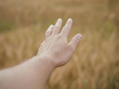 Close up of a hand reaching during a stretch.